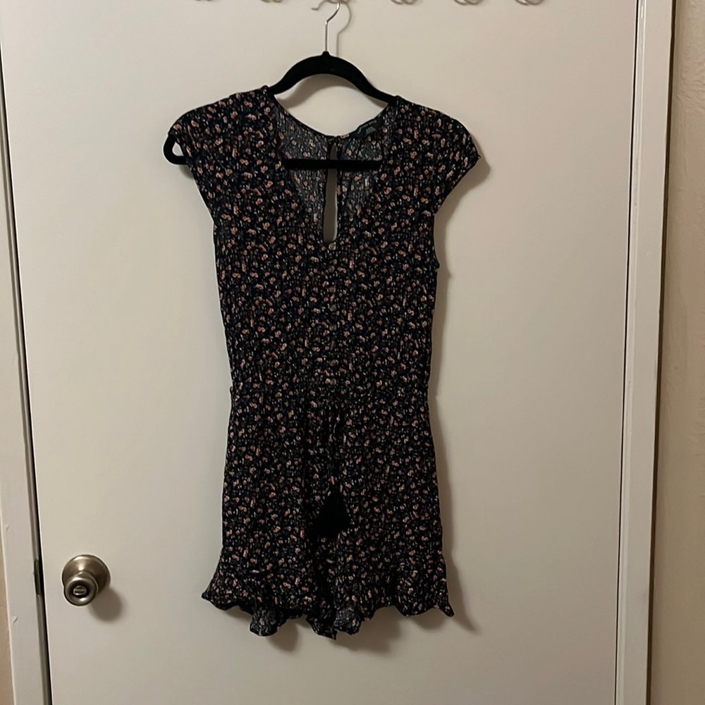 Dark blue romper with flowers in a size small